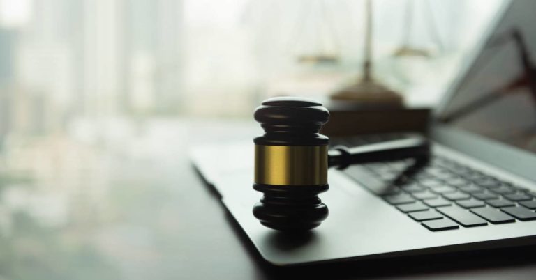 Gavel rests on laptop keyboard | Kendall PC